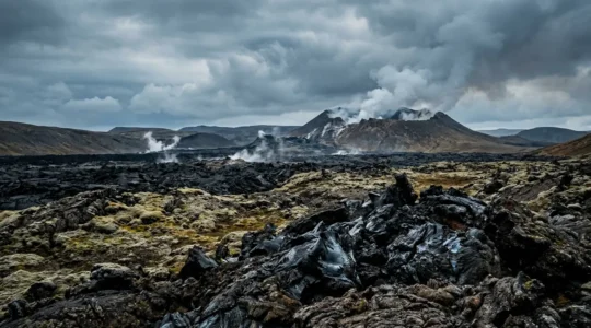 Paysage volcanique islandais avec fumerolles et coulees de lave recentes sous un ciel dramatique